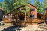 Experience rustic charm in this beautiful wooden home, nestled amongst tall trees.