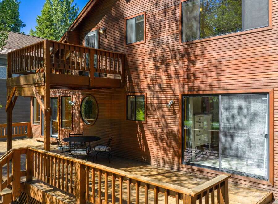 Experience outdoor living at its finest on this expansive wooden deck, perfect for entertaining or enjoying a quiet morning.