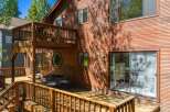Experience outdoor living at its finest on this expansive wooden deck, perfect for entertaining or enjoying a quiet morning.