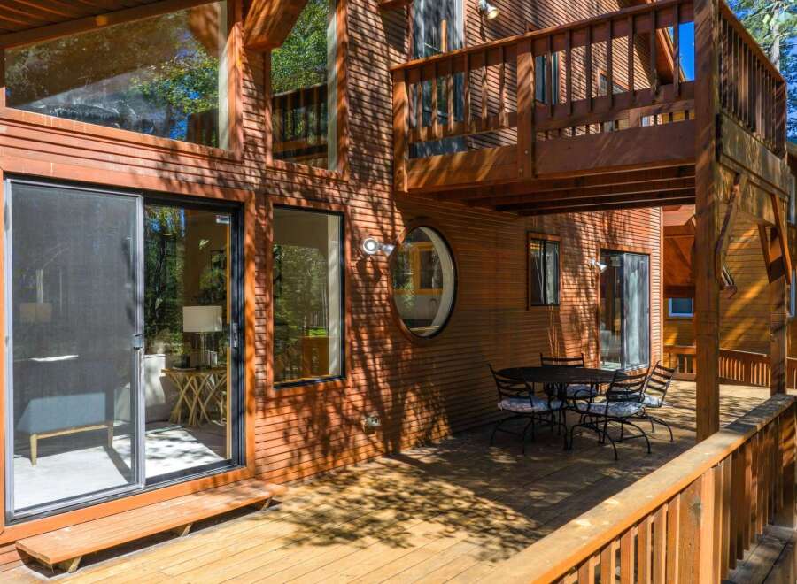 Experience rustic charm and modern comfort in this stunning wooden home, featuring expansive windows that invite natural light and scenic views.