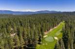 Experience luxury living nestled amidst a pristine pine forest with this stunning aerial view.