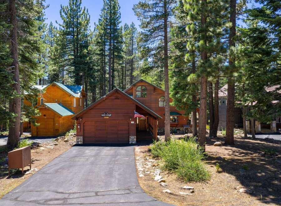 Nestled amongst towering pine trees, this charming wooden cabin offers a serene mountain retreat.