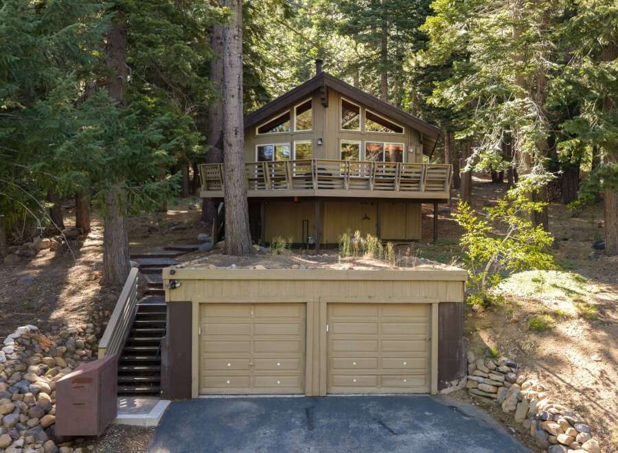 Nestled amidst towering trees, this charming cabin offers a serene mountain retreat.