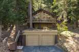 Nestled amidst towering trees, this charming cabin offers a serene mountain retreat.
