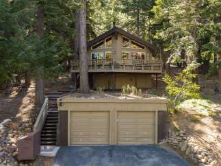 Nestled amidst towering trees, this charming cabin offers a serene mountain retreat.