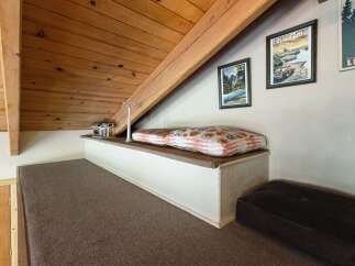 Discover this charming loft space, perfect for relaxation or an extra sleeping area.