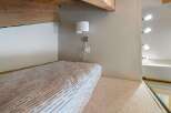 This cozy loft space features a comfortable bed with a striped duvet, perfect for a relaxing retreat.