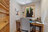 This charming home office features a built-in desk with a granite countertop, perfect for productivity.