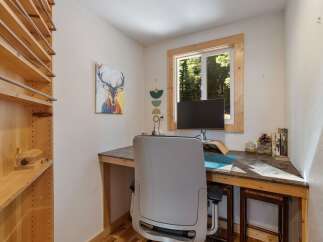This charming home office features a built-in desk with a granite countertop, perfect for productivity.
