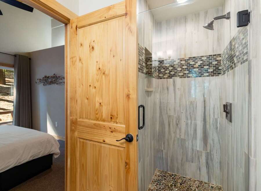 Step into this beautifully appointed bathroom featuring a spacious walk-in shower with elegant tile work and modern fixtures.