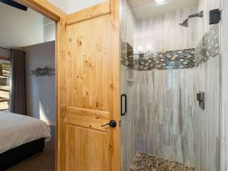 Step into this beautifully appointed bathroom featuring a spacious walk-in shower with elegant tile work and modern fixtures.