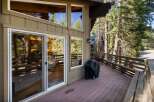 Enjoy outdoor living on this spacious deck, perfect for entertaining or relaxing amidst the serene forest setting.