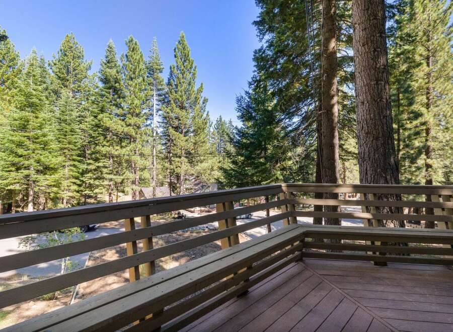 Enjoy the serene mountain views from this charming deck, complete with a built-in bench perfect for relaxing outdoors.