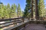Enjoy the serene mountain views from this charming deck, complete with a built-in bench perfect for relaxing outdoors.
