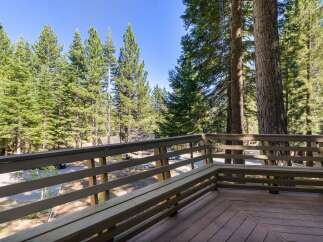 Enjoy the serene mountain views from this charming deck, complete with a built-in bench perfect for relaxing outdoors.