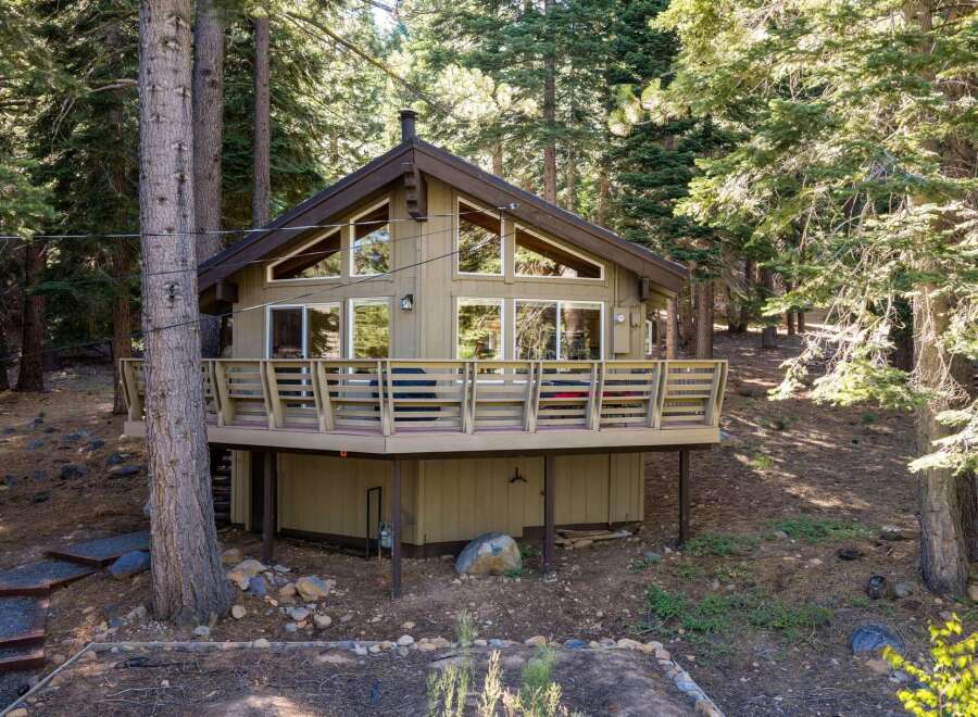 Nestled among tall pine trees, this charming cabin offers a serene mountain retreat.