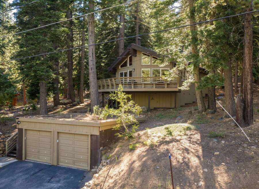 Nestled amidst towering pine trees, this charming mountain home offers a serene retreat.