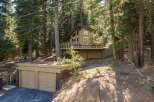 Nestled amidst towering pine trees, this charming mountain home offers a serene retreat.
