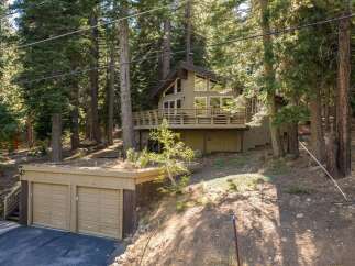 Nestled amidst towering pine trees, this charming mountain home offers a serene retreat.