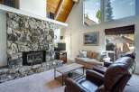 Experience cozy living in this charming mountain retreat, featuring a magnificent floor-to-ceiling stone fireplace as the centerpiece of the living room.
