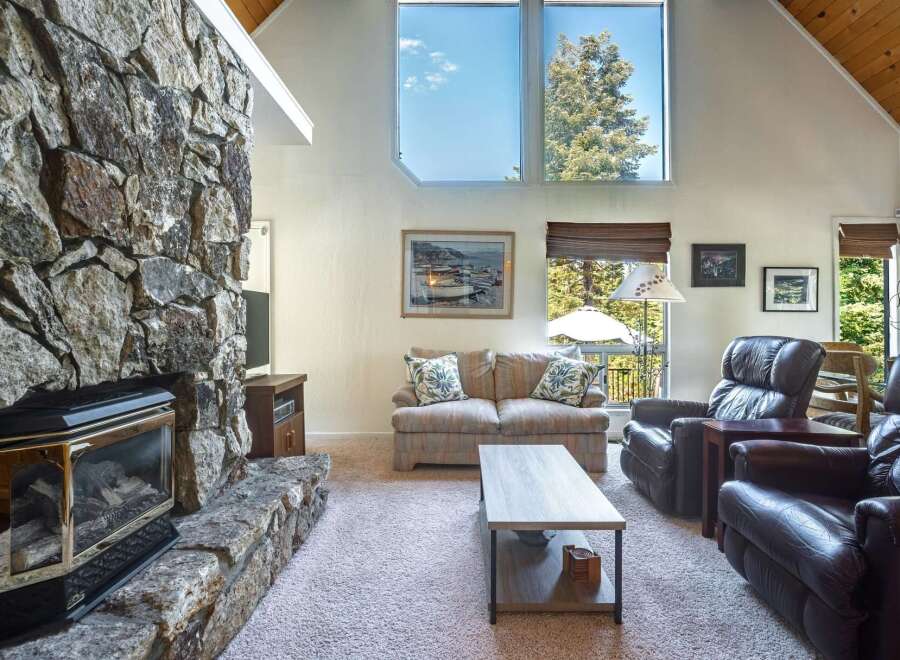 Experience cozy living with this stunning stone fireplace, perfect for gathering on cool evenings.