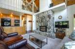 Experience the cozy charm of this mountain retreat, featuring a stunning floor-to-ceiling stone fireplace as the centerpiece of the living area.