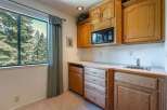 This charming kitchenette area features a built-in microwave, a convenient sink, and ample cabinet and drawer storage, perfect for a guest suite or in-law unit.