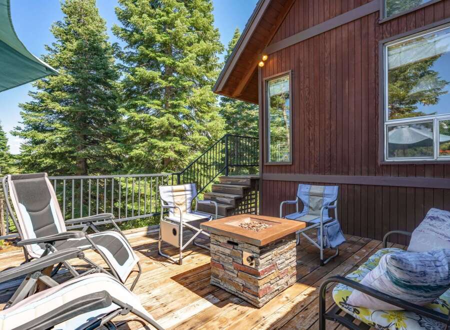 Enjoy the great outdoors from this spacious deck, complete with a stone fire pit and comfortable seating.