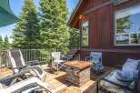 Enjoy the great outdoors from this spacious deck, complete with a stone fire pit and comfortable seating.