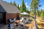 Enjoy outdoor living on this spacious wooden deck, complete with a gas grill, fire pit, and comfortable seating.