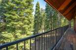 Enjoy breathtaking views from this stunning balcony, surrounded by majestic evergreen trees.