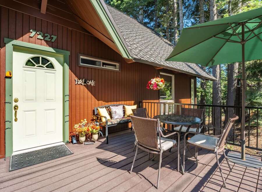 Welcome guests to this charming cabin retreat with a delightful front porch.