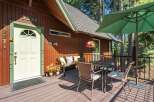 Welcome guests to this charming cabin retreat with a delightful front porch.