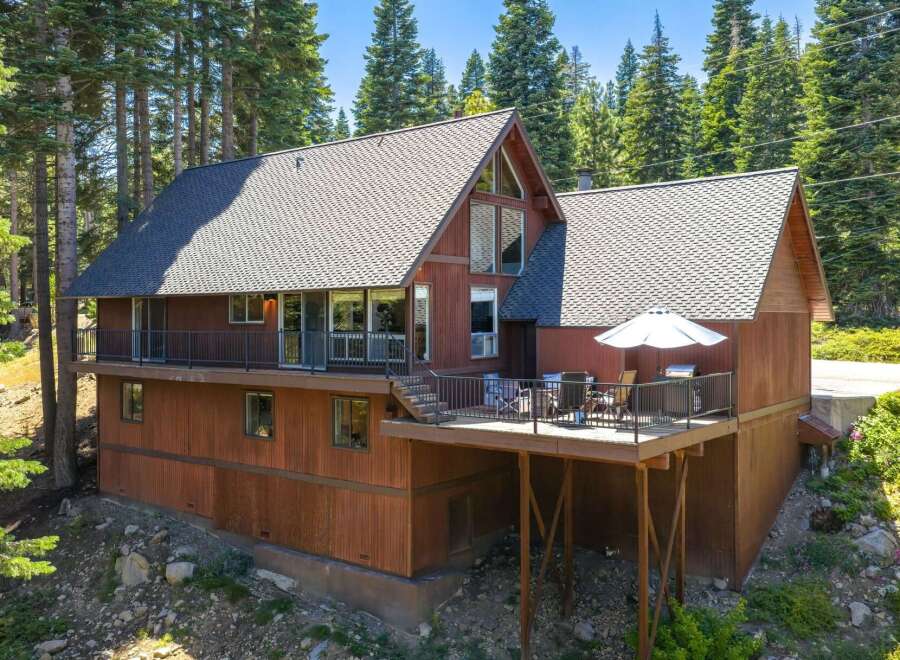 Nestled amidst towering pine trees, this charming mountain home offers a serene retreat.