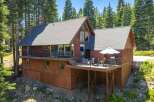 Nestled amidst towering pine trees, this charming mountain home offers a serene retreat.