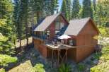 Nestled amidst towering pine trees, this charming wooden cabin offers a serene mountain retreat.