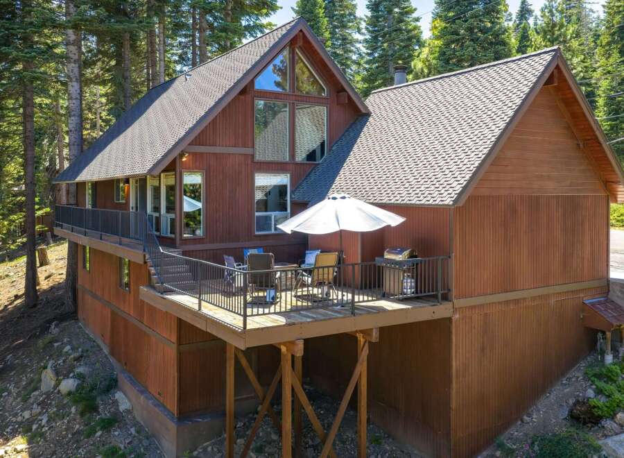 Experience mountain living in this charming wood-sided home nestled among tall pine trees.