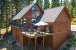 Experience mountain living in this charming wood-sided home nestled among tall pine trees.