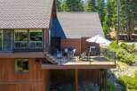 Enjoy outdoor living on this spacious deck, complete with a grill and seating area, perfect for entertaining.