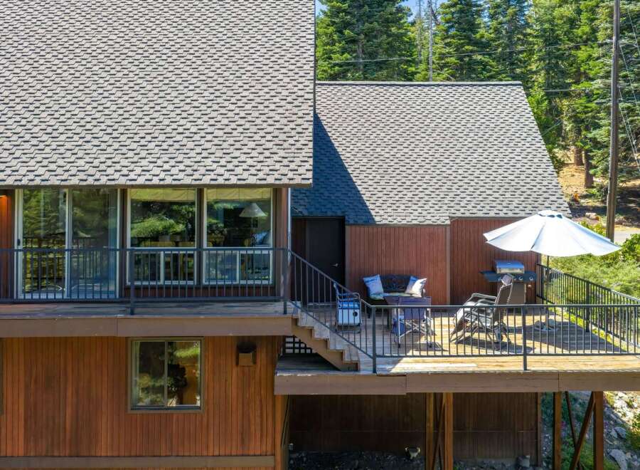 Enjoy outdoor living on this spacious deck, complete with a grill and umbrella for sunny days.