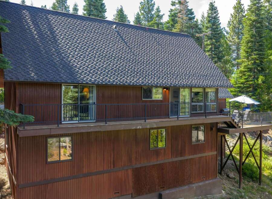 Nestled amidst towering pine trees, this charming wooden home offers a serene mountain retreat.