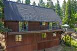 Nestled amidst towering pine trees, this charming wooden home offers a serene mountain retreat.
