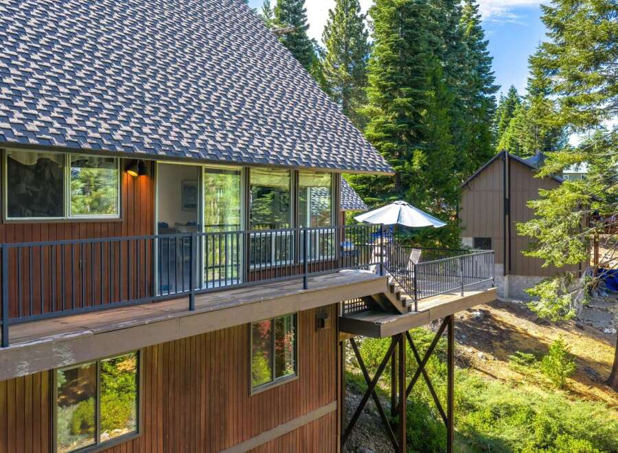 Experience mountain living with this stunning property featuring a spacious deck perfect for outdoor entertaining and enjoying the surrounding nature.