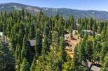 Nestled amidst a dense forest of towering pine trees, this property offers a secluded mountain retreat.