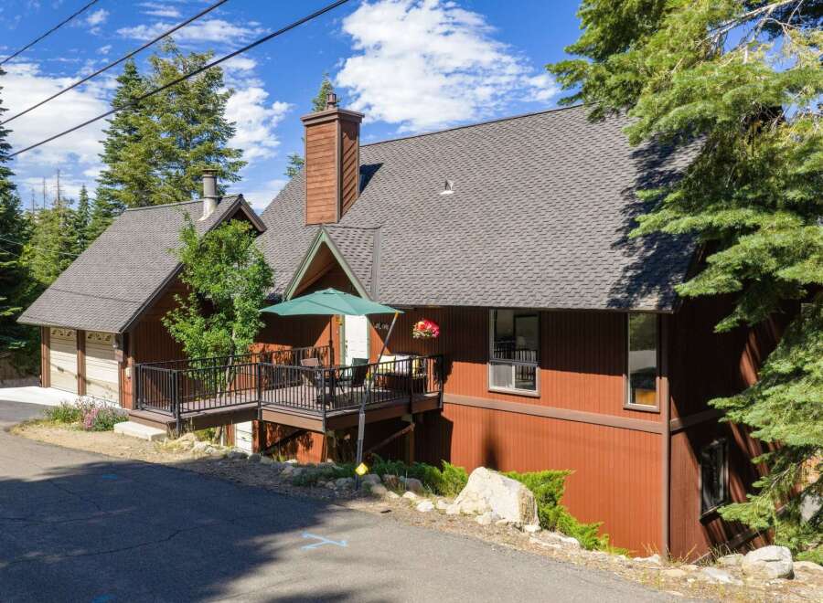 Nestled amidst tall pine trees, this charming mountain home offers a serene retreat.
