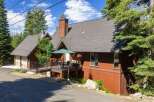 Nestled amidst tall pine trees, this charming mountain home offers a serene retreat.