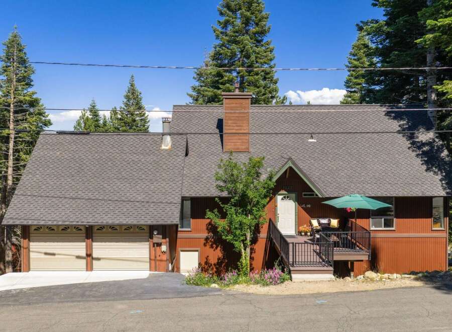 Nestled among tall pine trees, this charming mountain home offers a serene retreat.
