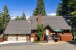 Nestled among tall pine trees, this charming mountain home offers a serene retreat.