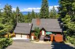 Nestled amidst towering pine trees with a stunning lake view, this charming mountain home offers a serene escape.