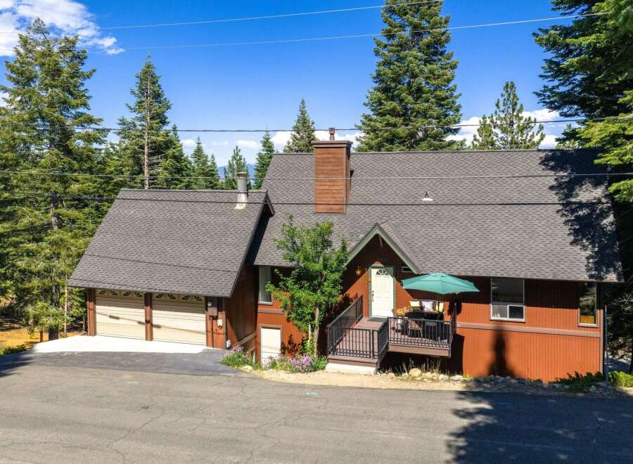 Nestled amidst towering pine trees, this charming mountain home offers a serene retreat.
